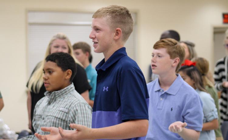 Childress County 4-H members recite the 4-H pledge at the 2022-2023 Year-End Awards Banquet Tuesday, Aug. 22 at the Fair Park City Auditorium. From left: Bryson Session, Sterling Bruce, Ryker Schaefer. The Red River Sun/Elizabeth Tanner