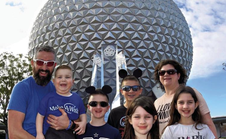 The Downing family, including Noah, left, Clive, Jack, Simon, Penny, Heather and Nora, received a Make-AWish Disney World trip to Orlando, Fla. Doctors have recommended a life-saving kidney transplant for Clive, a Head Start student at Wellington Elementary School. Courtesy Photo