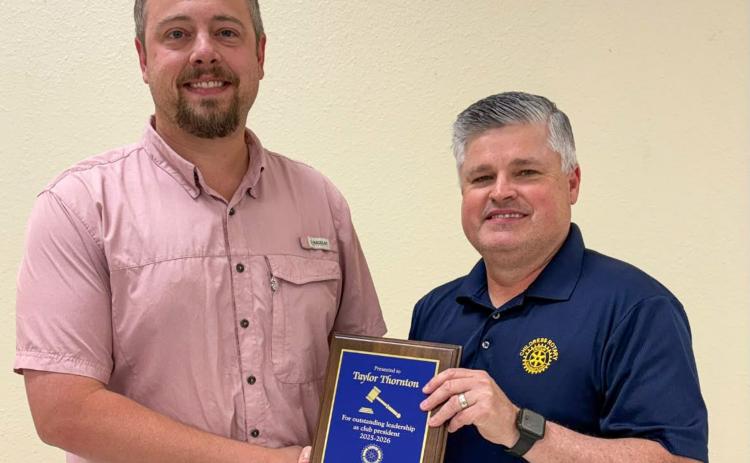The Childress Rotary Club, represented by Reagan Garrison, honors President Taylor Thornton, left, for an outstanding year of leadership and dedicated service. CHILDRESS ROTARY CLUB