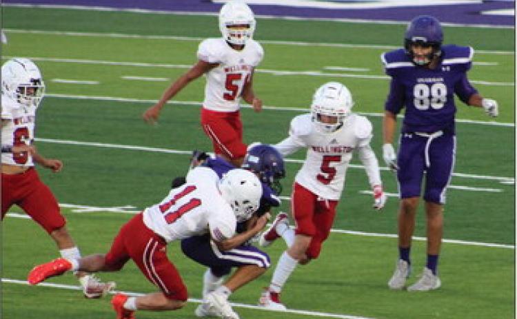 Junior varsity Rocket Conner Bowen (11) takes down a Spearman Lynx near the endzone with Carson Kane (5), Kingston Molina (51) and KJ Molina (64) assisting in the stop. Wellington maintains its perfect 3-0 record with the 14-6 win Thursday, Sept. 14 at Lynx Stadium. The Red River Sun/Shauna Salinas