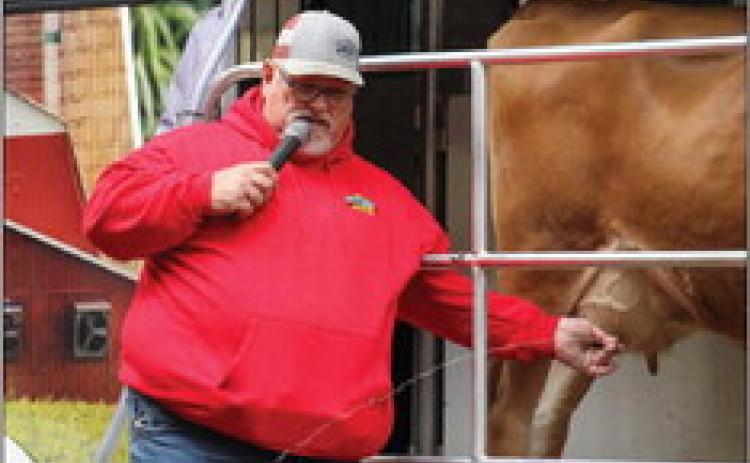 Southwest Dairy Farmers Mobile Dairy Classroom instructor Todd Griffin milks three-year-old Jersey milk cow Buttercup during Childress County Ag Day Wednesday, Oct. 26 at the Mashburn Event Center and Arena. For additional photos, see 2B. The Red River Sun/Elizabeth Tanner