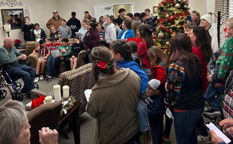 Residents of Parkview Manor Assisted Living listen as Wellington Youth of all denominations convene for a Christmas caroling event Wednesday evening, Dec. 20. Wellington Care Center residents received a visit as well. Students climbed aboard a hayride at Collingsworth County Courthouse for the cold evening of caroling. Courtesy Photo