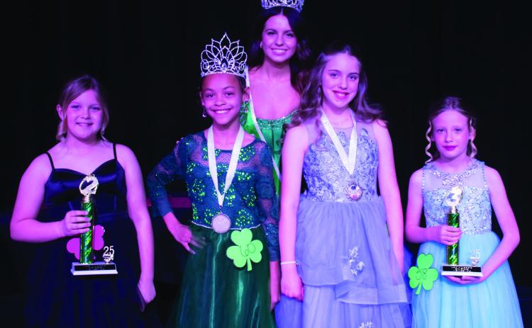 Wellington Elementary School fourth-grader Alaeja Archie, second from left, wins first place and Best Smile in the Young Miss division of the 78th Annual Shamrock St. Patrick’s Day Celebration Lad n’ Lassie Pageant Sunday, March 16, on the Shamrock High School stage. Other winners include, from left, Lainey Copenhaver, second place; Elena Barefoot, Most Photogenic; and Jade Hays, third place. Miss Irish Rose 2025 Taylor Sullivan, back, presented the honors. County Star-News