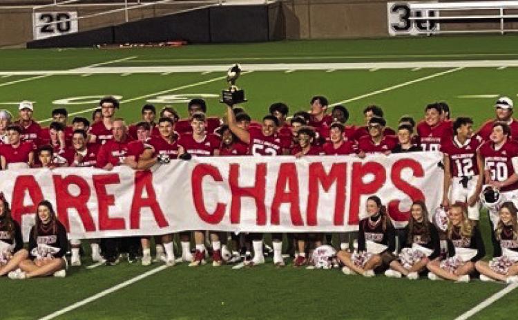 Senior Skyrocket Israel Acosta hoists the Class 2A Division II Area Championship trophy into the air following the 70-0 victory against the Morton Indians Thursday, Nov. 16 at Happy State Bank Stadium in Canyon. See story, page 1B. Courtesy Photo