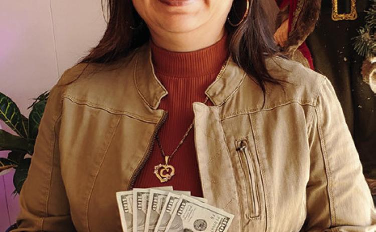 Photo Courtesy of Memphis Chamber of Commerce Claudia Perez claims her cash prize of $500 Wednesday, Dec. 14 after she was drawn as the winner of Memphis Chamber of Commerce’s shop local drawing, which aimed to support local merchants and urge citizens to buy in Memphis this holiday season. “Shopping local supports our community,” Memphis Chamber of Commerce Manager Kim Cloyd said. “Every person here benefits from local businesses.”