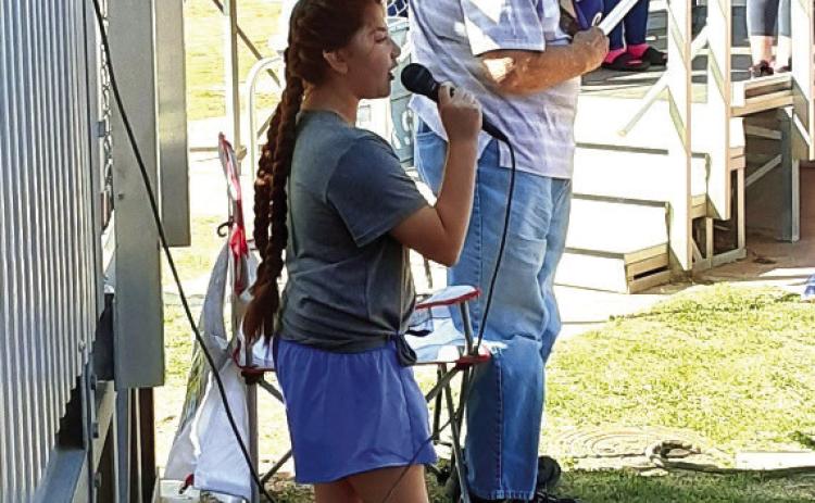 Monson Music’s Bella Blu Sanders performs at softball game