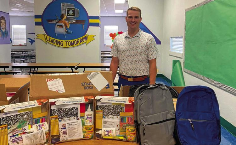 Childress Elementary School accepts a school supply donation from Silas Ragsdale – State Farm Insurance Office Manager Travis Brooks. “Thank you to Travis Brooks from State Farm Insurance for bringing some school supplies for our students,” Childress Elementary School Principal Tracey Blake said. Photo Courtesy of Childress Elementary School