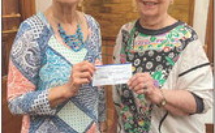 Modern Home Club’s Soundra Christy, right, presents a $300 donation to Childress County Christmas Sharing Board Member Raenell Smith. Courtesy Photos