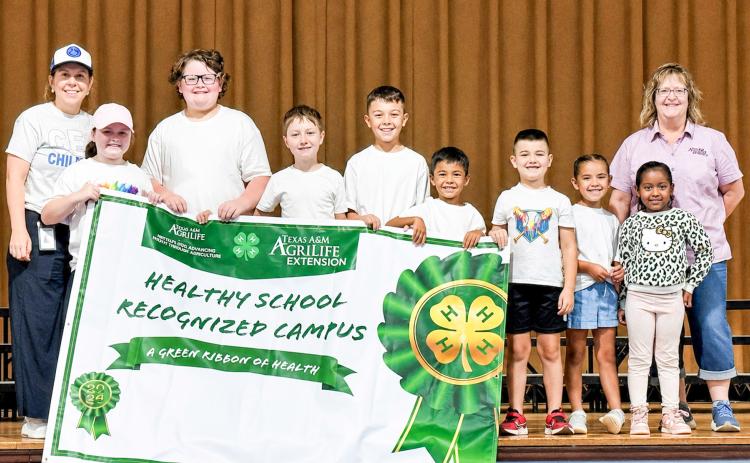 Childress Elementary School is recognized as a Healthy School Recognized Campus — a designation awarded to the school by the Texas A&amp;M AgriLife Extension Service. From left: Childress Elementary School Principal Tracey Blake, Karter Sherwood, McCrae Detwiler, Dawson Adcock, Evan Rodriguez, Cruze Rodriguez, Kopper Sherwood, Taylinn Brown, Hannah Harris, Texas A&amp;M AgriLife Extension Service of Childress County Family and Community Health Agent Sandra Moody. SHAYLEY ELLIOTT