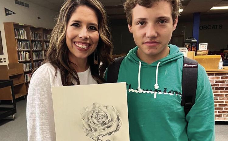 Childress High School (CHS) art student Landon Senn gifts CHS teacher Janet Pierce artwork featuring her “word of the year.” Photo Courtesy of Childress High School