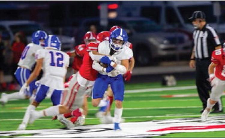 Childress’ Mark Willis carries a Holliday defender Friday, Sept. 15 at Eagle Stadium in Holliday. Press Pass Sports/Nicole Dill
