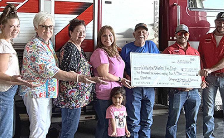 From left: Chamber President Cindy Weatherly, Chamber Treasurer Cameron Warren, Chamber Volunteers Nancy Harris and Margret Wood, Chamber Vice President Cari-Ann Wynn with Charlotte, Chamber Volunteer Billy Wilkerson, Wellington VFD Treasurer Ethan Cummings, Fireman Korn Wiebe, and Training Officer and Secretary Matt Wynn.