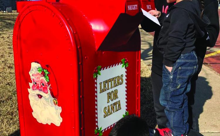 The sons of Tino and Shauna Salinas, Dahmian, Alejandro and TJ Salinas, come up with a plan to get a letter to Santa. Photo by Neal Odom