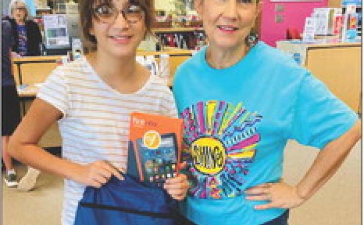 Wellington Junior High School sixth-grader Emma Zaragoza, left, accepts the grand prize Kindle for the Teen Summer Reading drawing at Collingsworth Public Library. Librarian Vicki Decker congratulates Zaragoza. Courtesy Photo