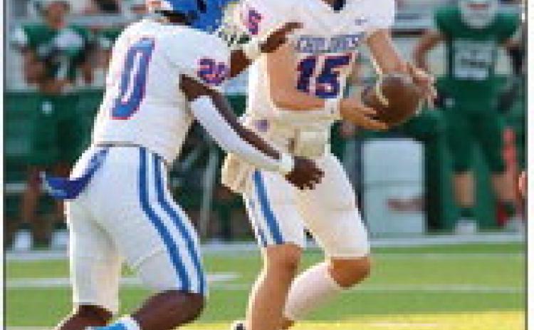 Childress quarterback Drake Rabe (15) hands the ball off to Da’Reon Mathis (20) Friday, Sept. 1 at Buckaroo Stadium. Photos by Childress High School Yearbook Staff