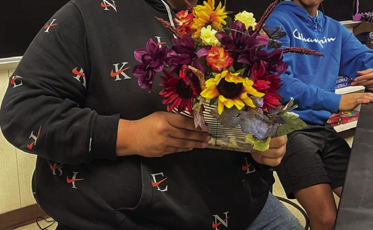 Floral design students upcycle tin cans