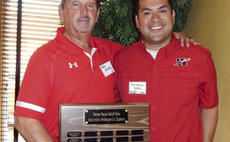 Wade Williams, left, Wellington High School (WHS) Class of 1983, shows appreciation for the honor of 2023 Rocket House Hall of Fame inductee during the 2023 Wellington Ex-Student Association reunion festivities Saturday morning, Aug. 5, 2023, at the Wellington Ritz Theatre lobby venue. WHS Principal Jermaine Cantu, WHS Class of 2002, served as master of ceremonies, announcing Williams as the honoree. The Red River Sun/Bev Odom