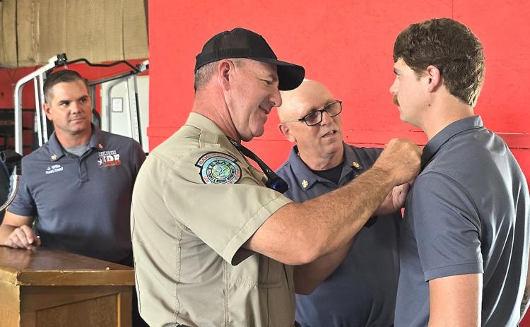 Tanner Thompson was promoted to Lieutenant and pinned by Chief Freeman and his father, Game Warden Matt Thompson, as Asst. Chief Wills looks on. INTREPID PHOTO / ROGER ESTLACK