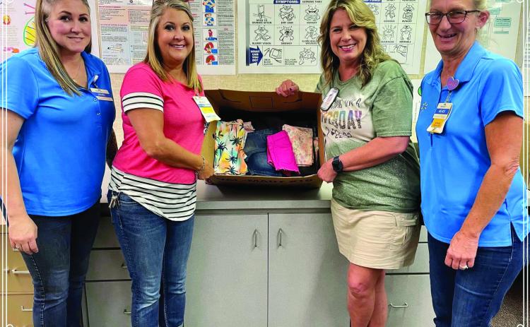 Walmart Supercenter donates clothing, which will be used when children need a change of clothes, to the Childress Elementary School nurse’s office Tuesday, Sept. 13. From left, Walmart employees Jamie Aguirre and Misty Willis, Childress Elementary School Nurse Cathy Hardin, and Walmart employee Mendi Walker. Photo Courtesy of Walmart
