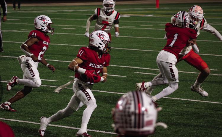 Skyrocket senior TJ Salinas (11) takes the handoff during Wellington’s 36-0 bi-district win against Petrolia Nov. 14 at Lawton, Okla. Salinas has been selected to play in the 2025 Native American All-Star Game, presented by Native American Athletic Foundation in partnership with the National Football League. The Red River Sun/Shauna Salinas