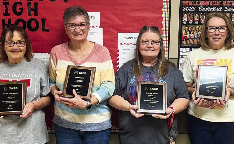 Ranee Foumentin, left, Debbie Scott, Georgia Brown and Dian Souder accept recognition upon their retirement for the years vested in Wellington Independent School District during the Friday, May 17 breakfast assembly at the Wellington High School Auditorium. Courtesy Photos