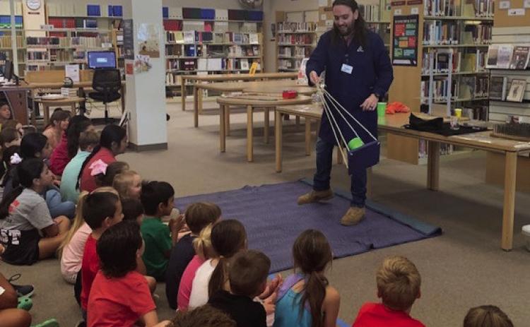 Students watch in awe as Tyler from Harrington Discovery Center makes science come alive in his Tuesday, June 20 presentation. All programs are free for Collingsworth Public Library’s “All Together Now” Summer Reading Program. Courtesy Photo