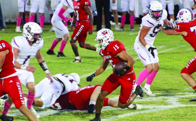 Wellington’s Anthony Ortiz (15) adds up yardage for the Skyrockets, while Dalton Holland (73), Travon Lewis (21), RJ Granadoz (60) and Dixon Dugan (50) hold Clarendon’s defense Friday, Oct. 11 at Powell Field in Wellington. The Red River Sun/Shauna Salinas